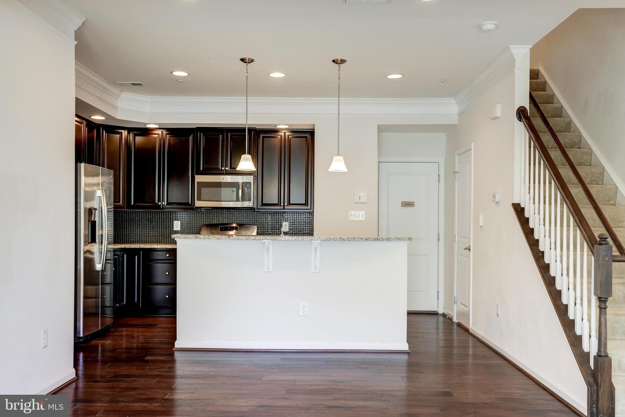 13643 Air And Parkway, Unit MUSEUM 9L Herndon, VA 20171 - Photo 11 of 45 a view of kitchen with wooden floor and electronic appliances