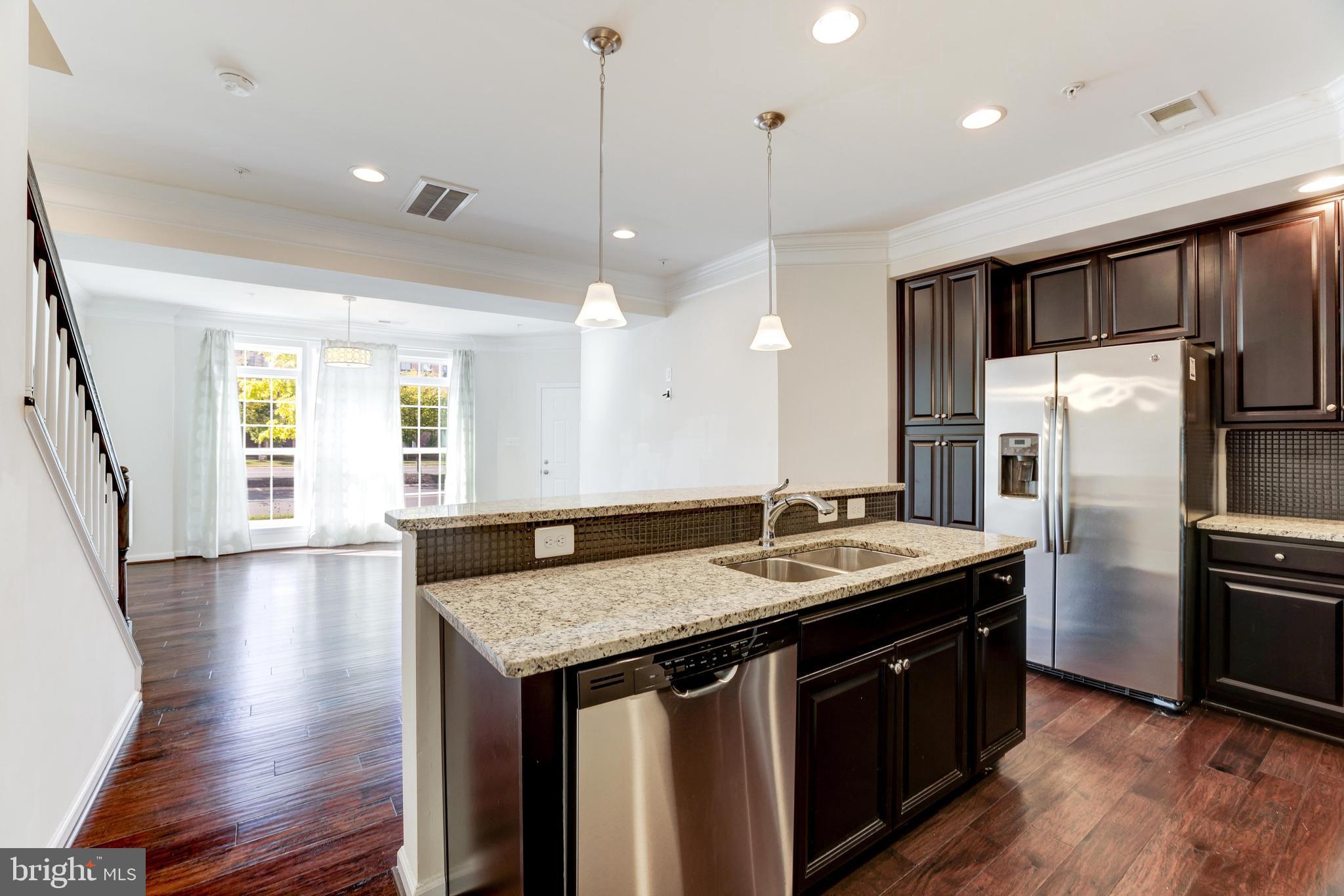 13643 Air And Parkway, Unit MUSEUM 9L Herndon, VA 20171 - Photo 17 of 45 a kitchen with stainless steel appliances granite countertop a sink a refrigerator and a stove