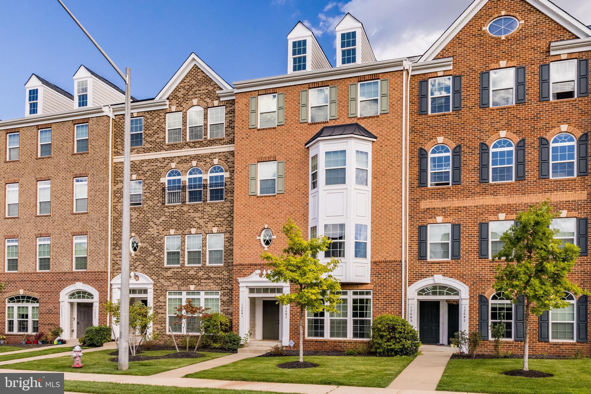 13643 Air And Parkway, Unit MUSEUM 9L Herndon, VA 20171 - Photo 2 of 45 a front view of a residential apartment building with a yard