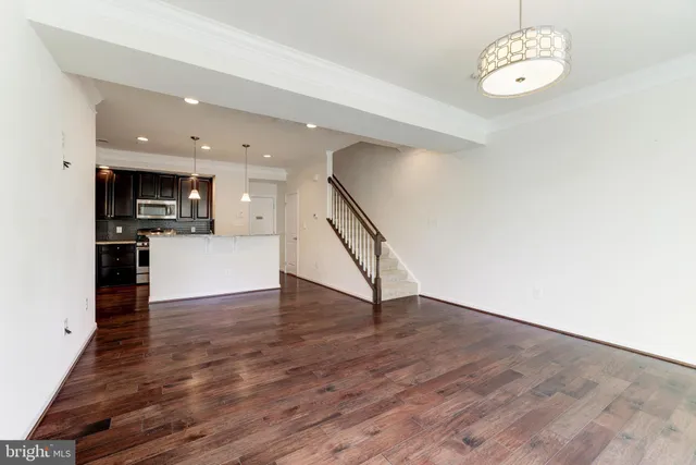 a view of a kitchen with a sink wooden floor and a large window