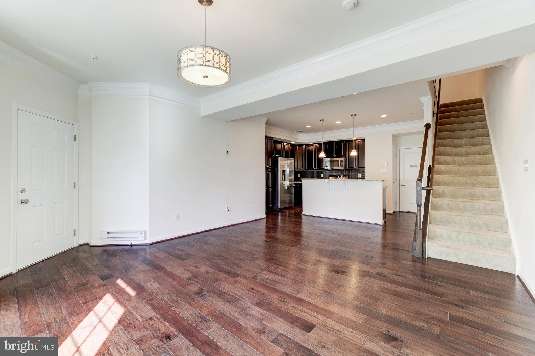 13643 Air And Parkway, Unit MUSEUM 9L Herndon, VA 20171 - Photo 9 of 45 a view of a room with wooden floor and kitchen view
