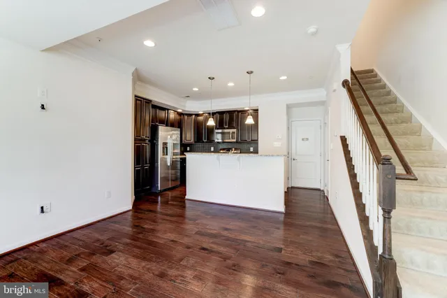 a view of kitchen with cabinets and wooden floor