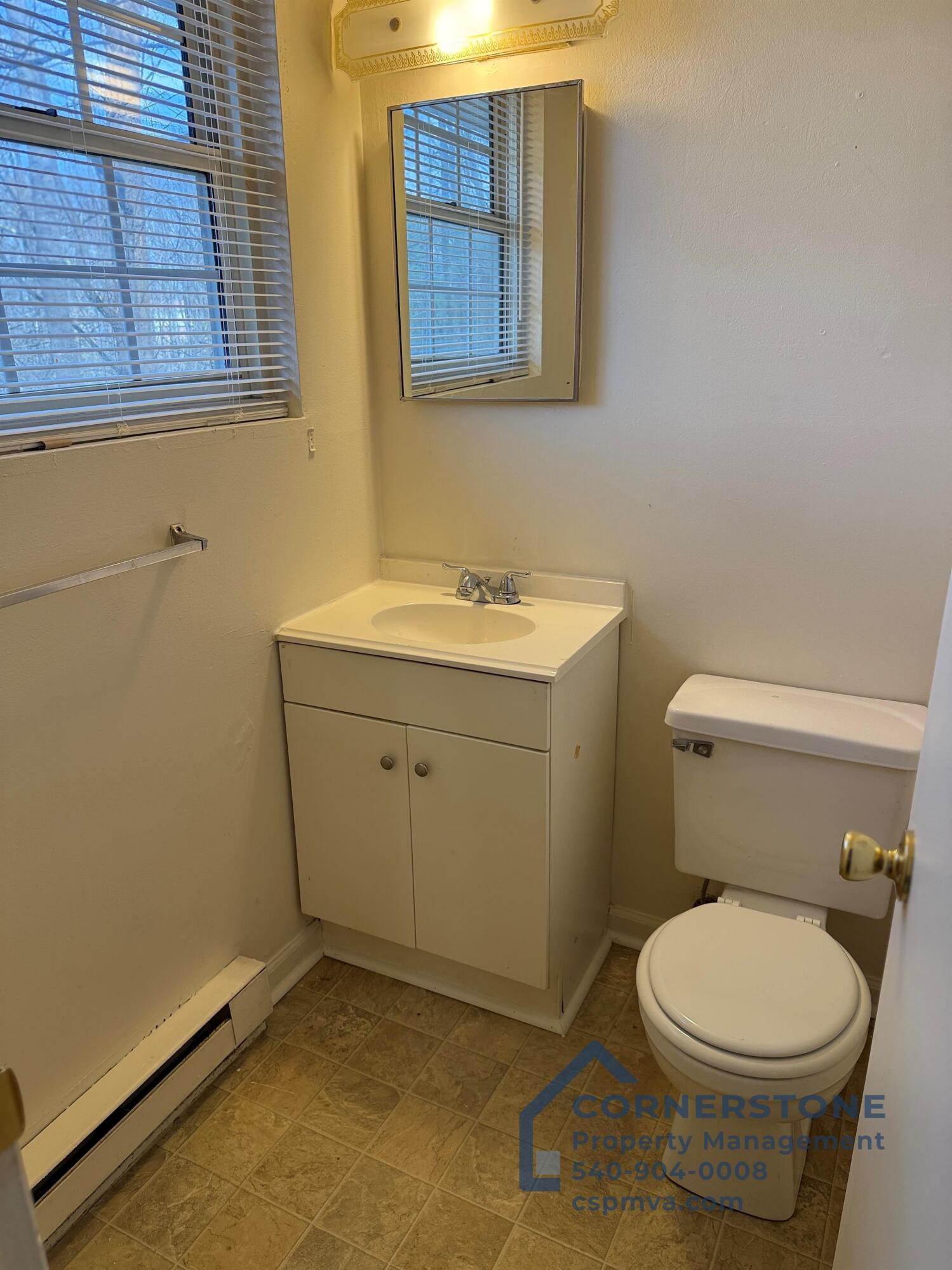 6700 Shingle Rdg Road, Unit 8B Roanoke, VA 24018 - Photo 12 of 13 a bathroom with a toilet sink and mirror