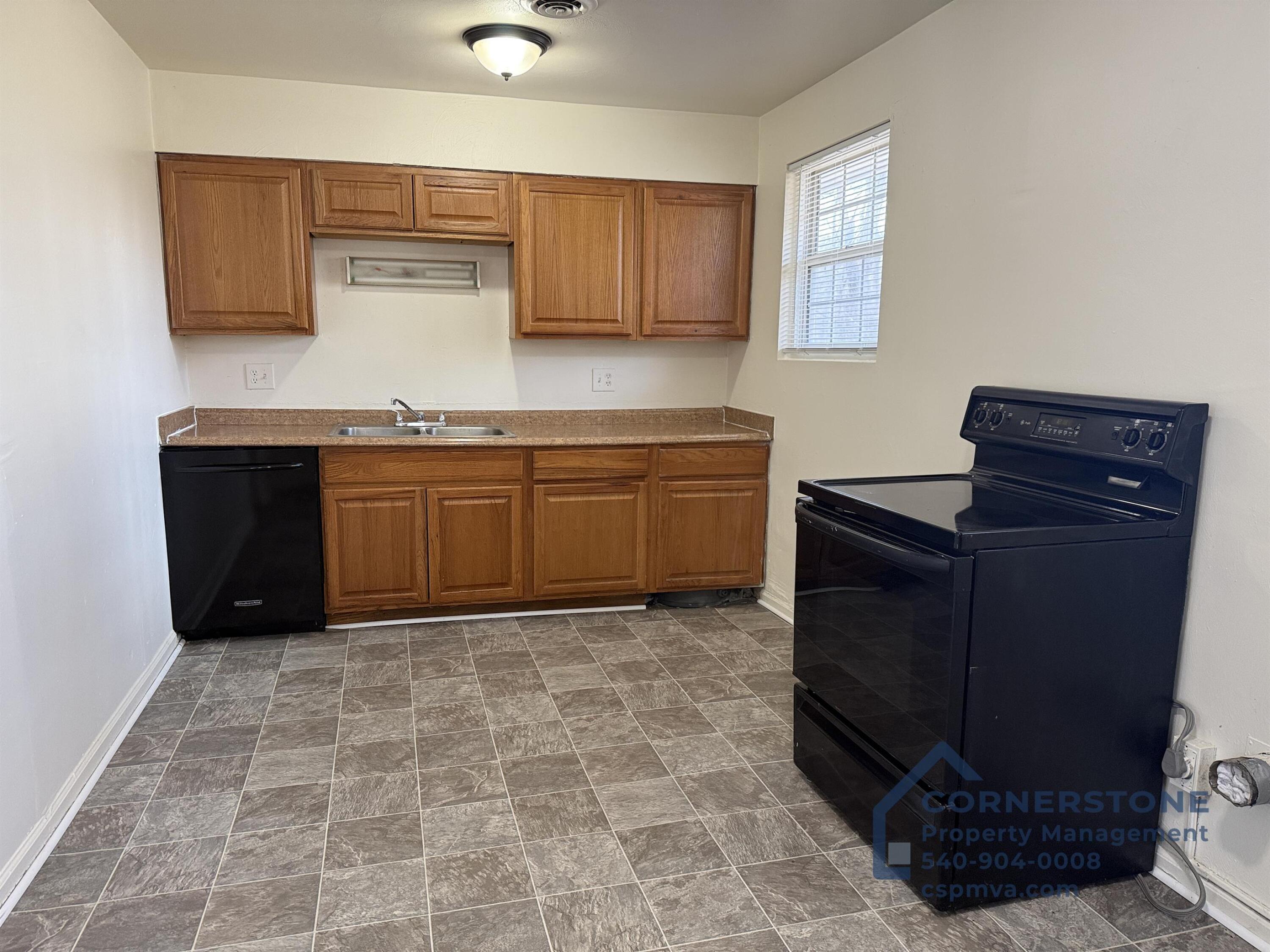 6700 Shingle Rdg Road, Unit 8B Roanoke, VA 24018 - Photo 5 of 13 a kitchen with granite countertop a stove a sink and a microwave
