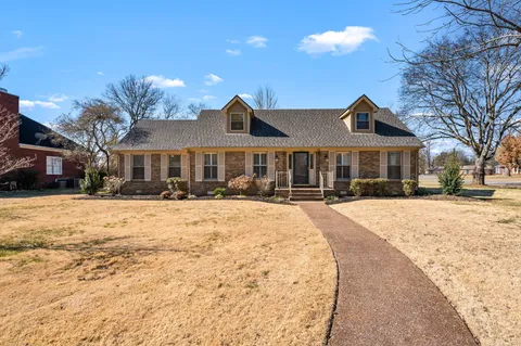 a kitchen with a sink cabinets stainless steel appliances and a window