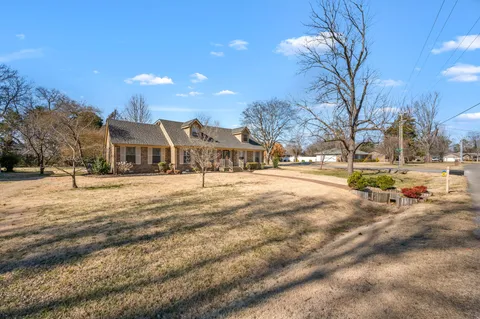 a view of an empty room with a chandelier fan