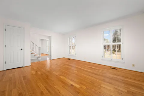 a view of a room with wooden floor