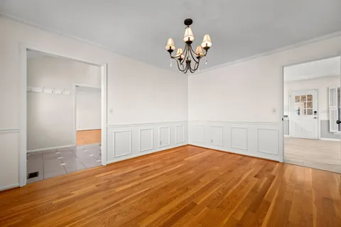 an empty room with a ceiling fan and a window