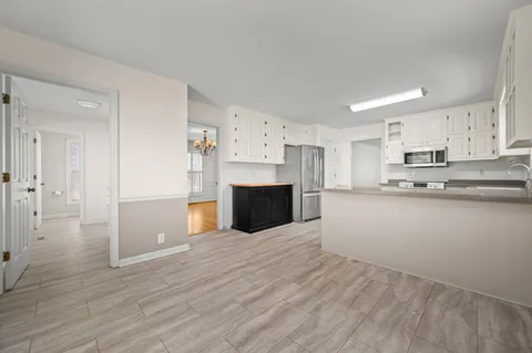 an empty room with fan and windows