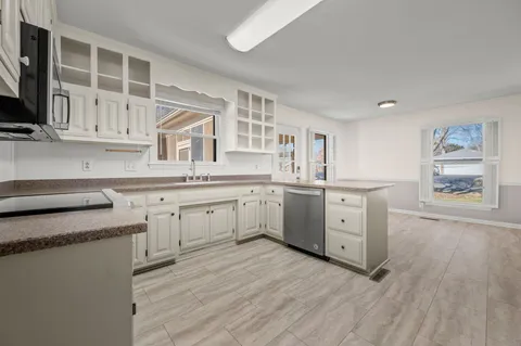 a front view of a house with a yard covered in snow