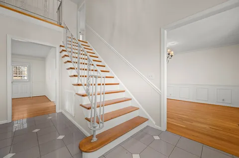 a view of entryway and hall with wooden floor