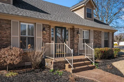 a view of a room with wooden floor and chandelier