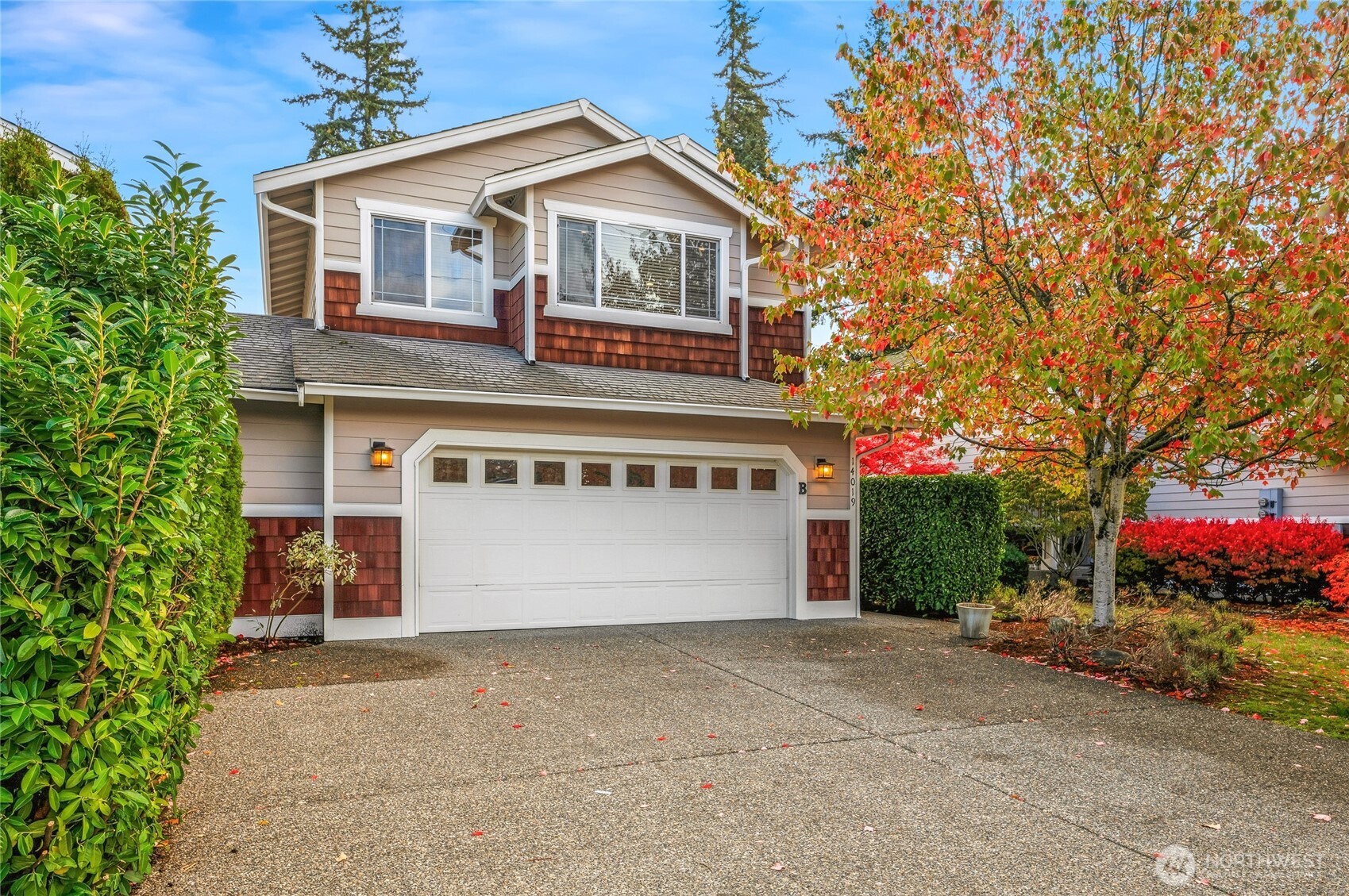 a front view of a house with a yard and garage