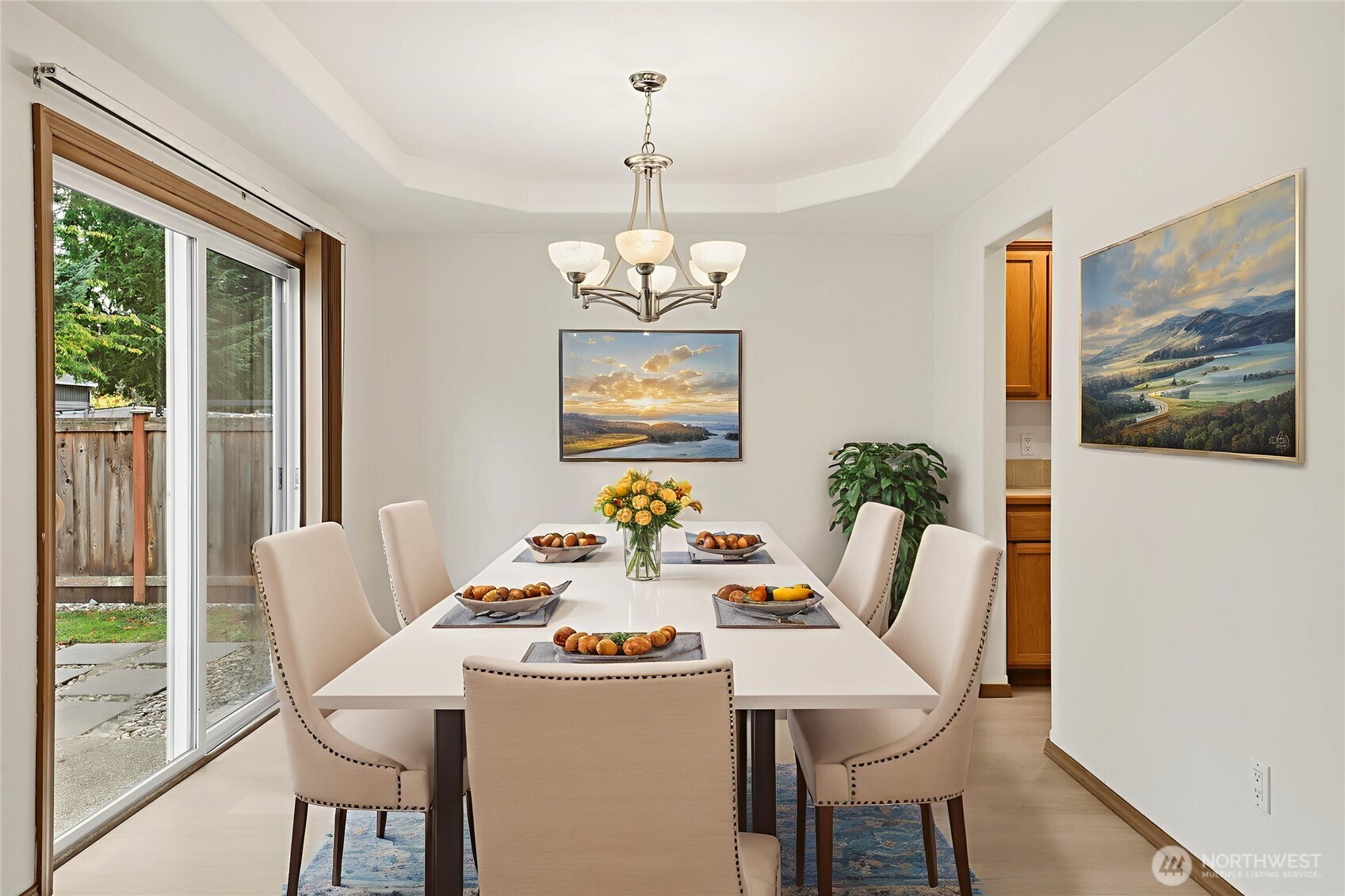 14019 52nd Avenue West, Unit B Edmonds, WA 98026 - Photo 12 of 38 a dining room with furniture a painting a chandelier and wooden floor