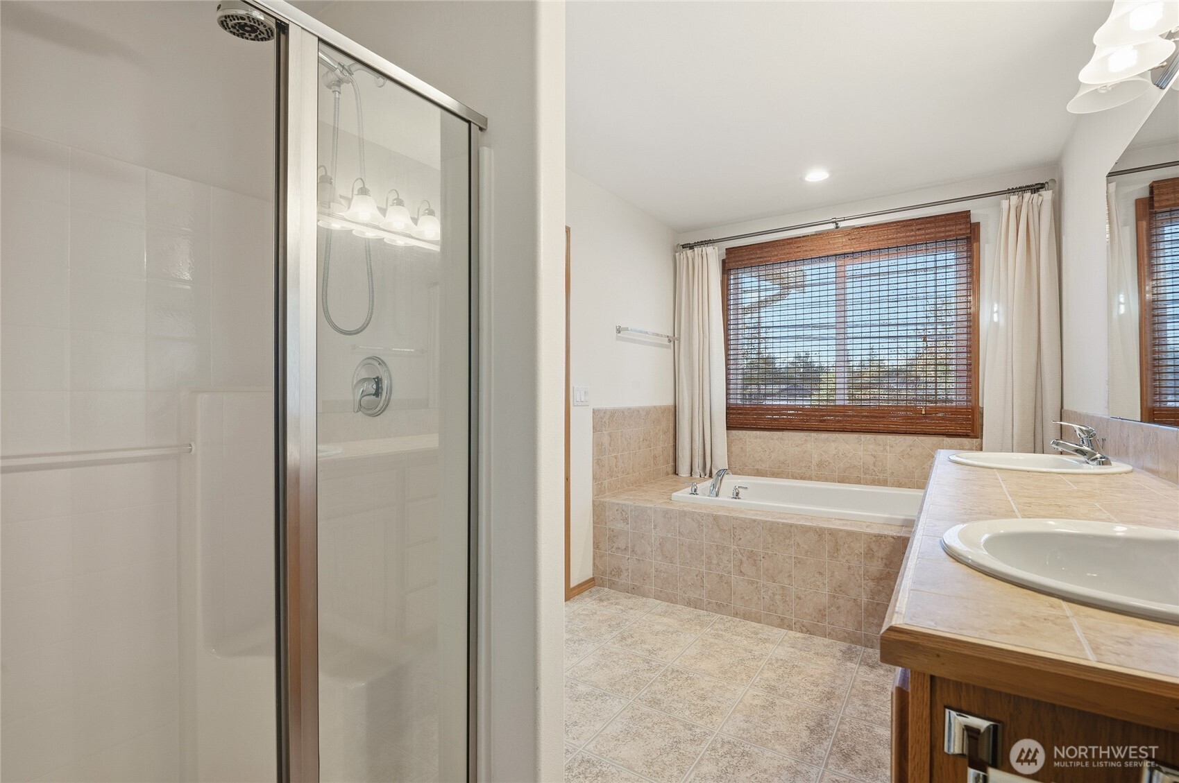 14019 52nd Avenue West, Unit B Edmonds, WA 98026 - Photo 24 of 38 a bathroom with a tub sink and mirror