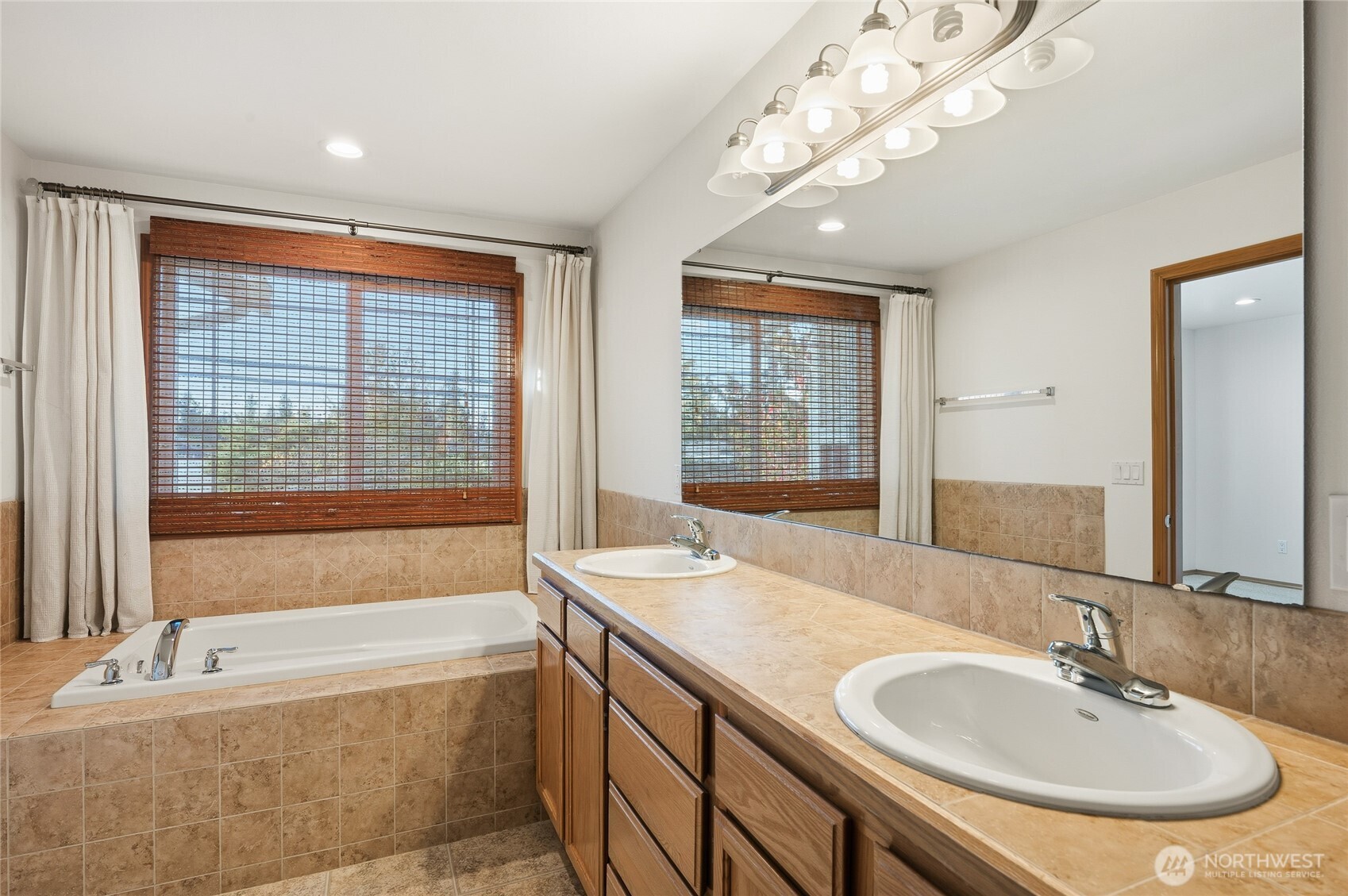 14019 52nd Avenue West, Unit B Edmonds, WA 98026 - Photo 26 of 38 a bathroom with a granite countertop sink and a bathtub