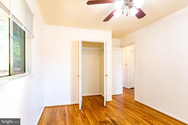a view of bedroom with a bed and wooden floor