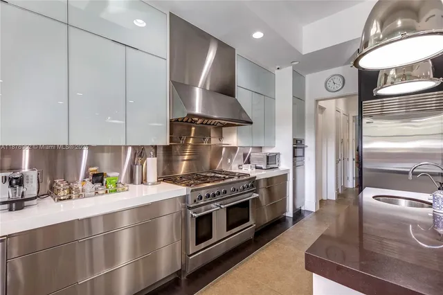 a kitchen with stainless steel appliances granite countertop a stove and a refrigerator