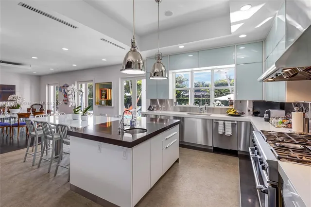 a kitchen with counter top space a sink stainless steel appliances and cabinets