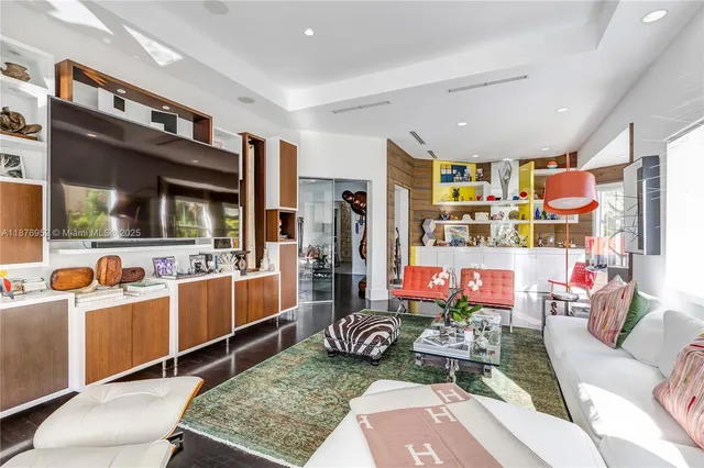 a living room with lots of furniture and clutter