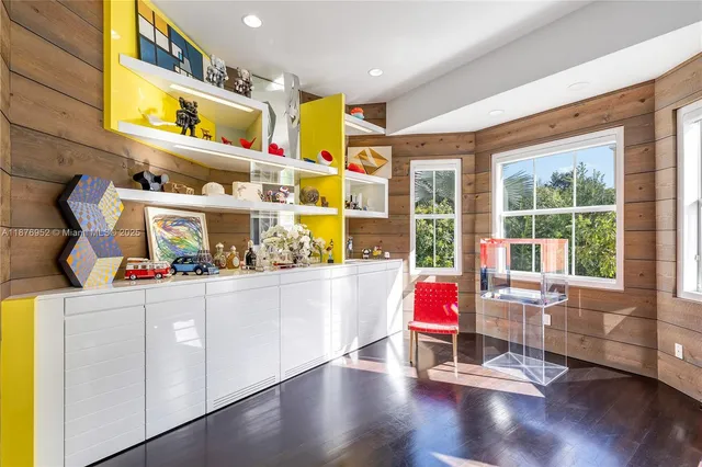 a room with musical instrument pool table and windows
