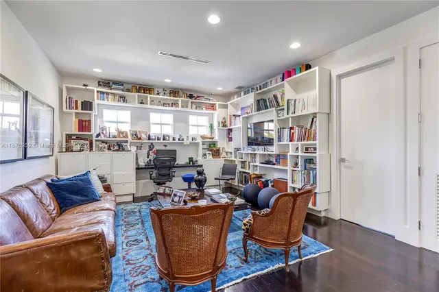 a living room with furniture and a book shelf