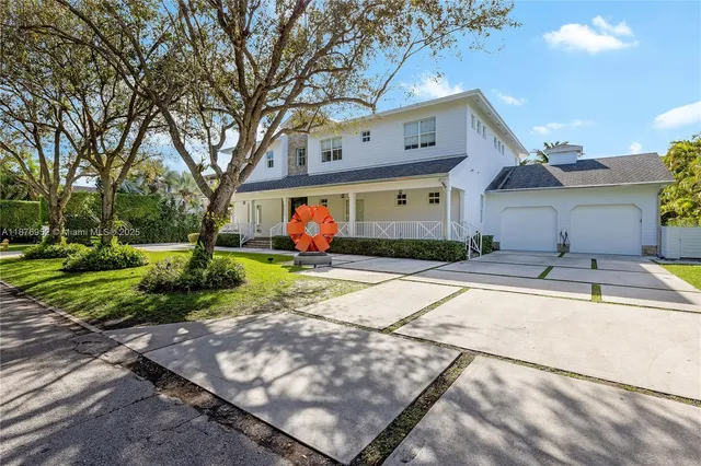 a front view of a house with a yard and a garden