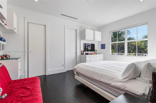 a bedroom with a large bed and a window