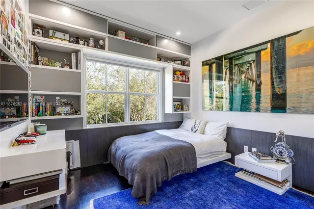 a bedroom with a bed furniture and a large window