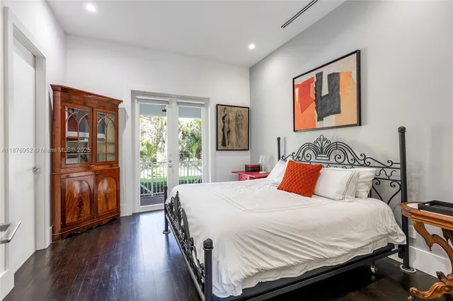 a bedroom with a large bed and a tv