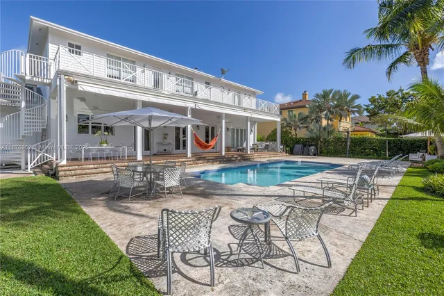 a view of a house with backyard and sitting area