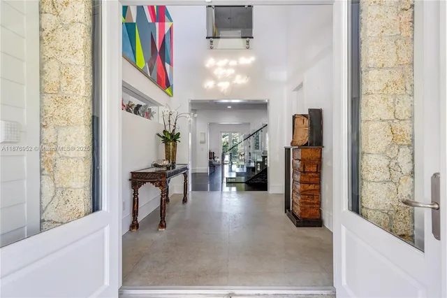 a view of a hallway with wooden floor and furniture