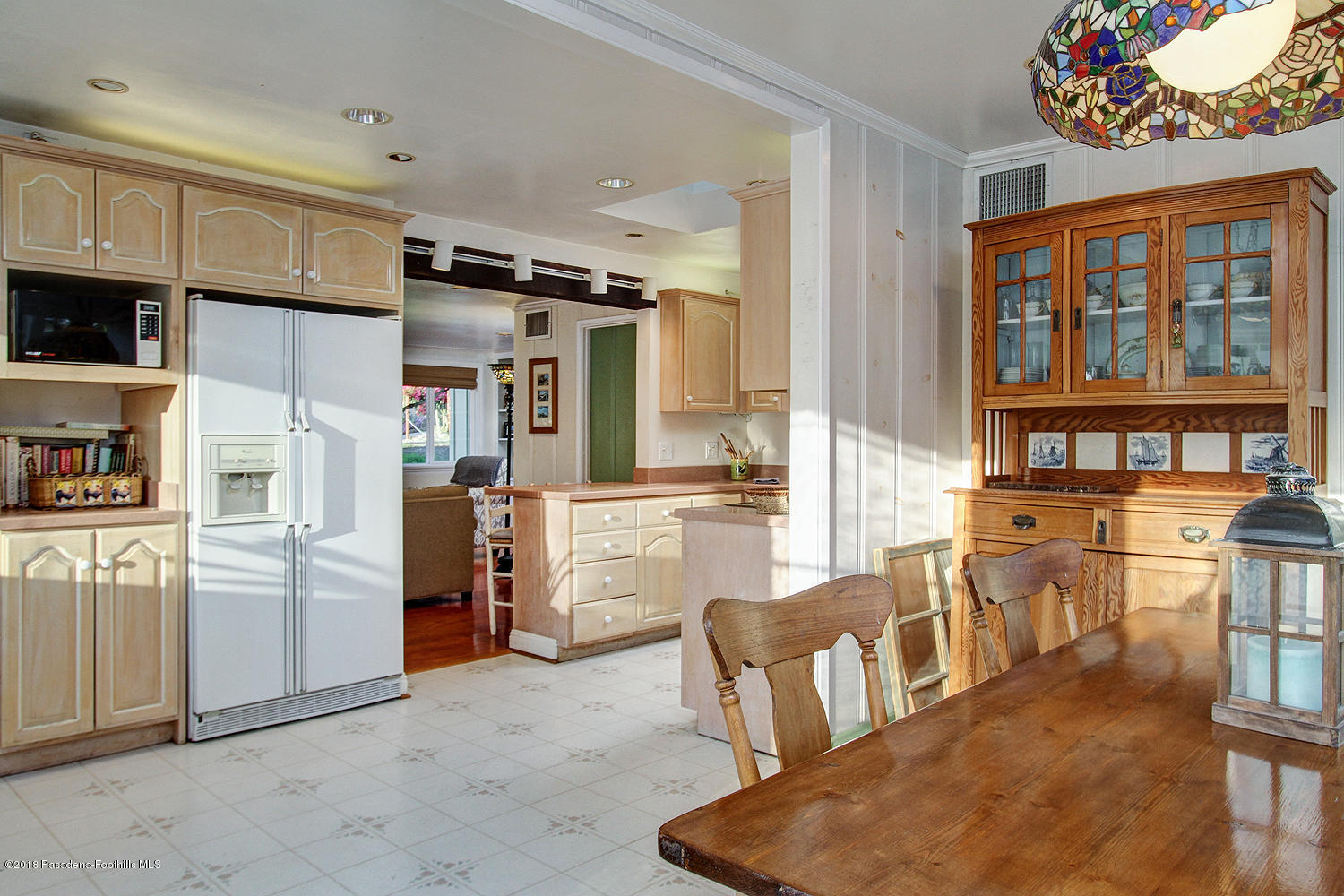 3501 Hollyslope Road Altadena, CA 91001 - Photo 14 of 35 a kitchen with stainless steel appliances kitchen island granite countertop a refrigerator and microwave