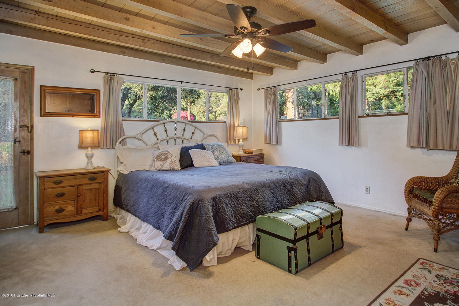 3501 Hollyslope Road Altadena, CA 91001 - Photo 16 of 35 a bedroom with a large bed and a chandelier