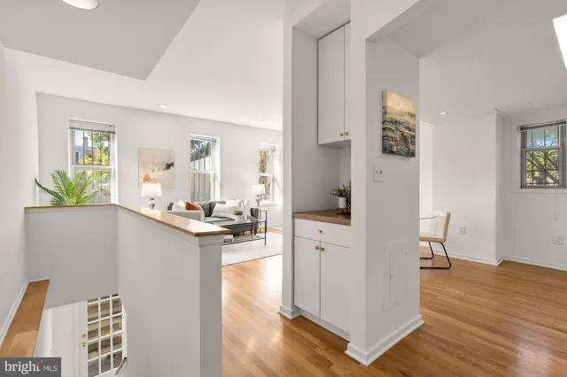 a view of living room and kitchen with wooden floor