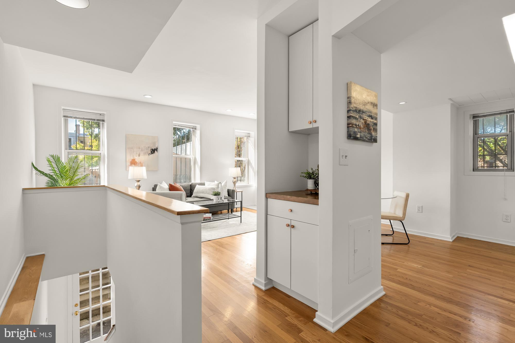 1341 East Capitol Street Southeast, Unit 107 Washington, DC 20003 - Photo 2 of 15 a view of living room and kitchen with wooden floor