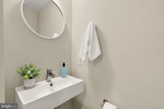 a bathroom with a sink and mirror