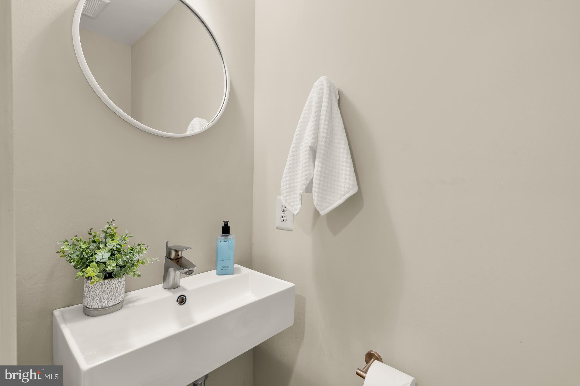 1341 East Capitol Street Southeast, Unit 107 Washington, DC 20003 - Photo 7 of 15 a bathroom with a sink and mirror