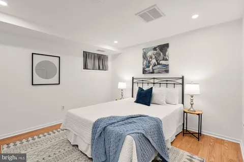 a bedroom with a bed and a lamp