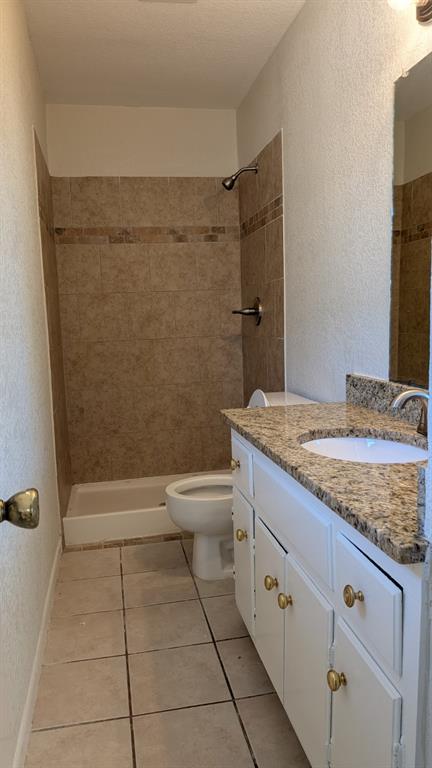 101 Pecan Street Howe, TX 75459 - Photo 12 of 16 White vanity with brass hardware, granite-style countertop, and integrated sink