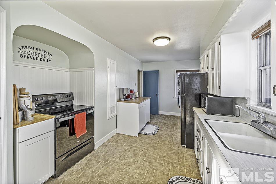 1339 Faland Way Reno, NV 89503 - Photo 4 of 15 a kitchen that has a sink a stove and a refrigerator