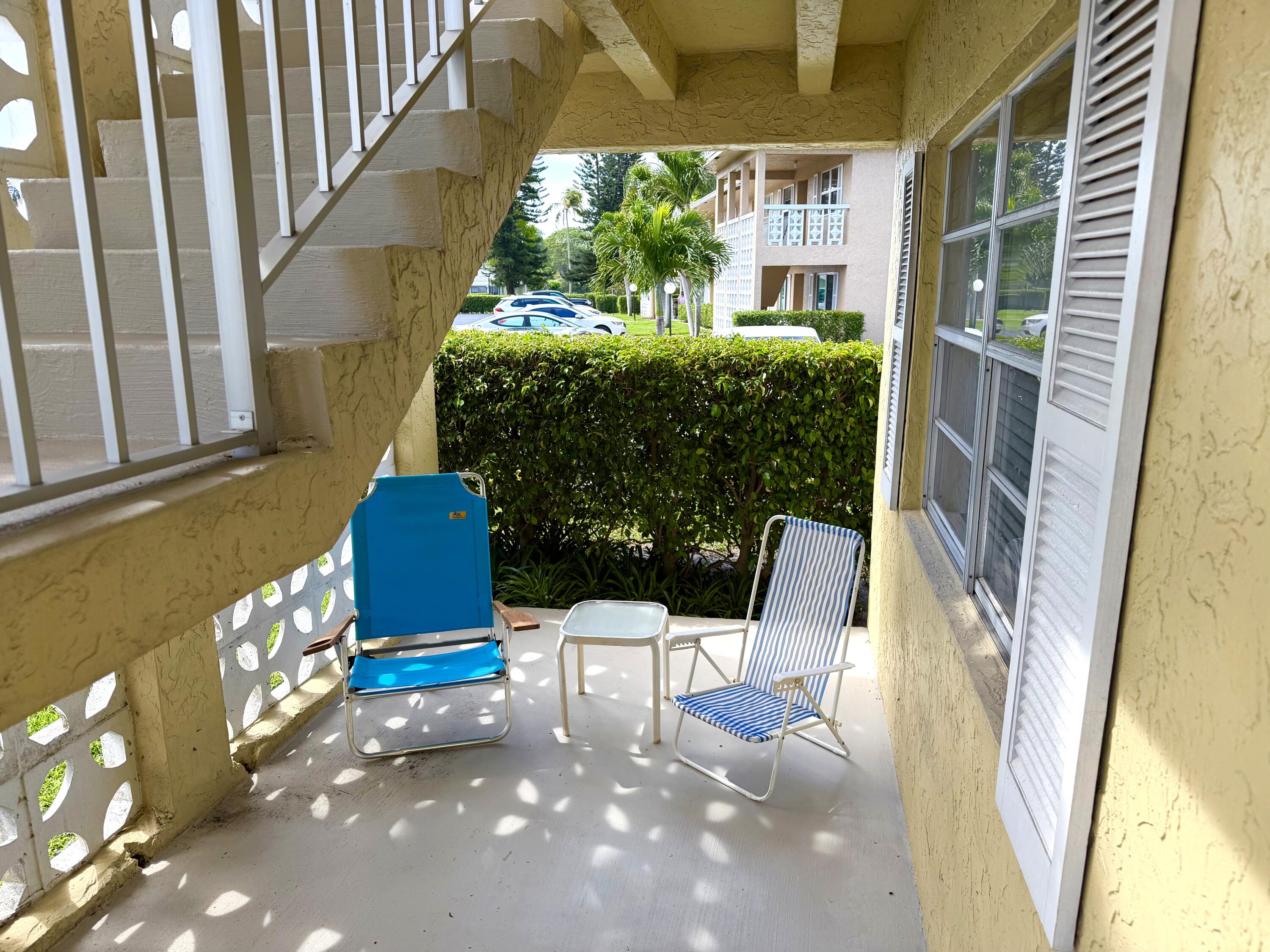 1141 Violet Terrace, Unit 101 Delray Beach, FL 33445 - Photo 2 of 20 under roof patio area