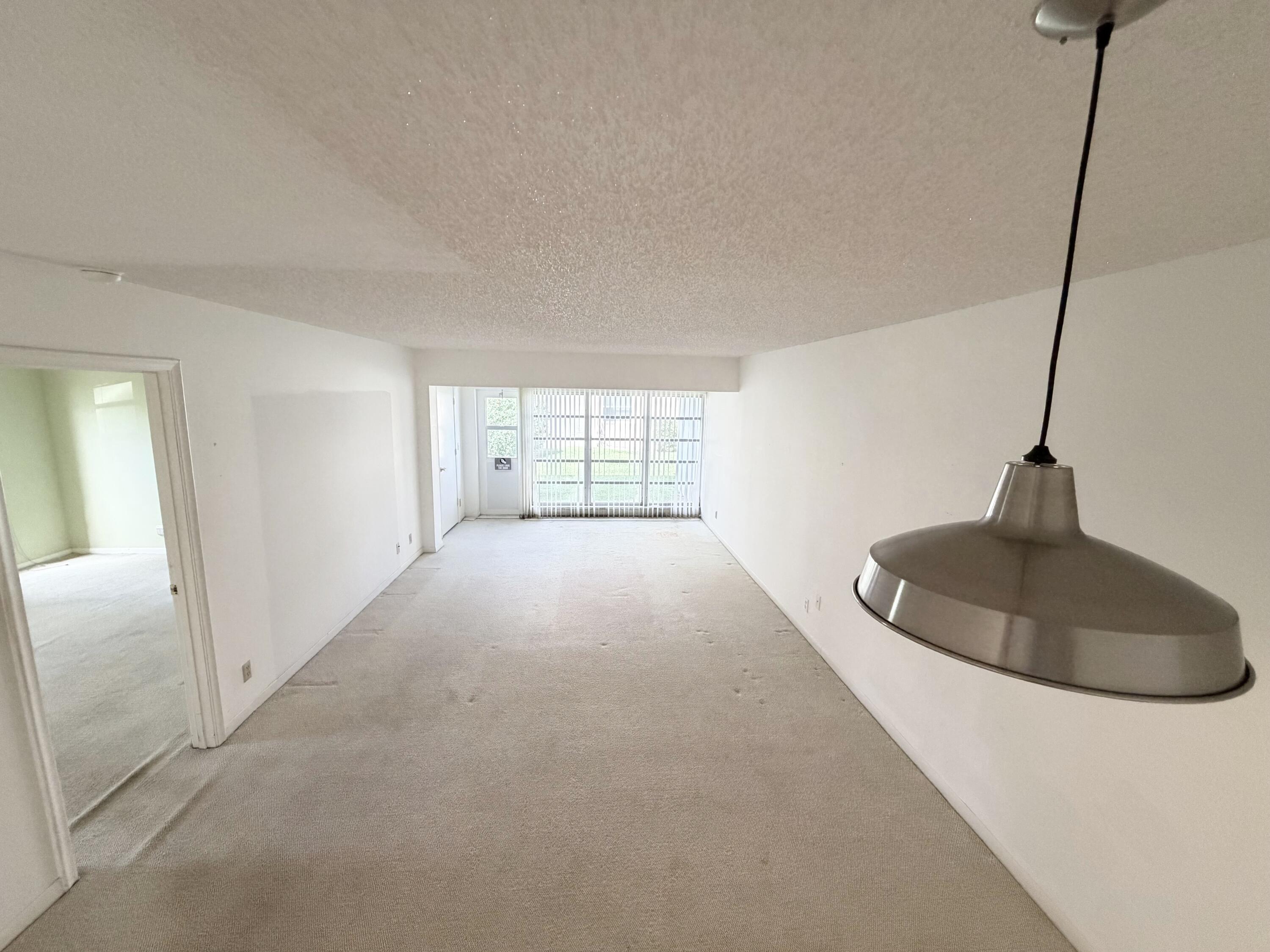 1141 Violet Terrace, Unit 101 Delray Beach, FL 33445 - Photo 5 of 20 Dining area to living room