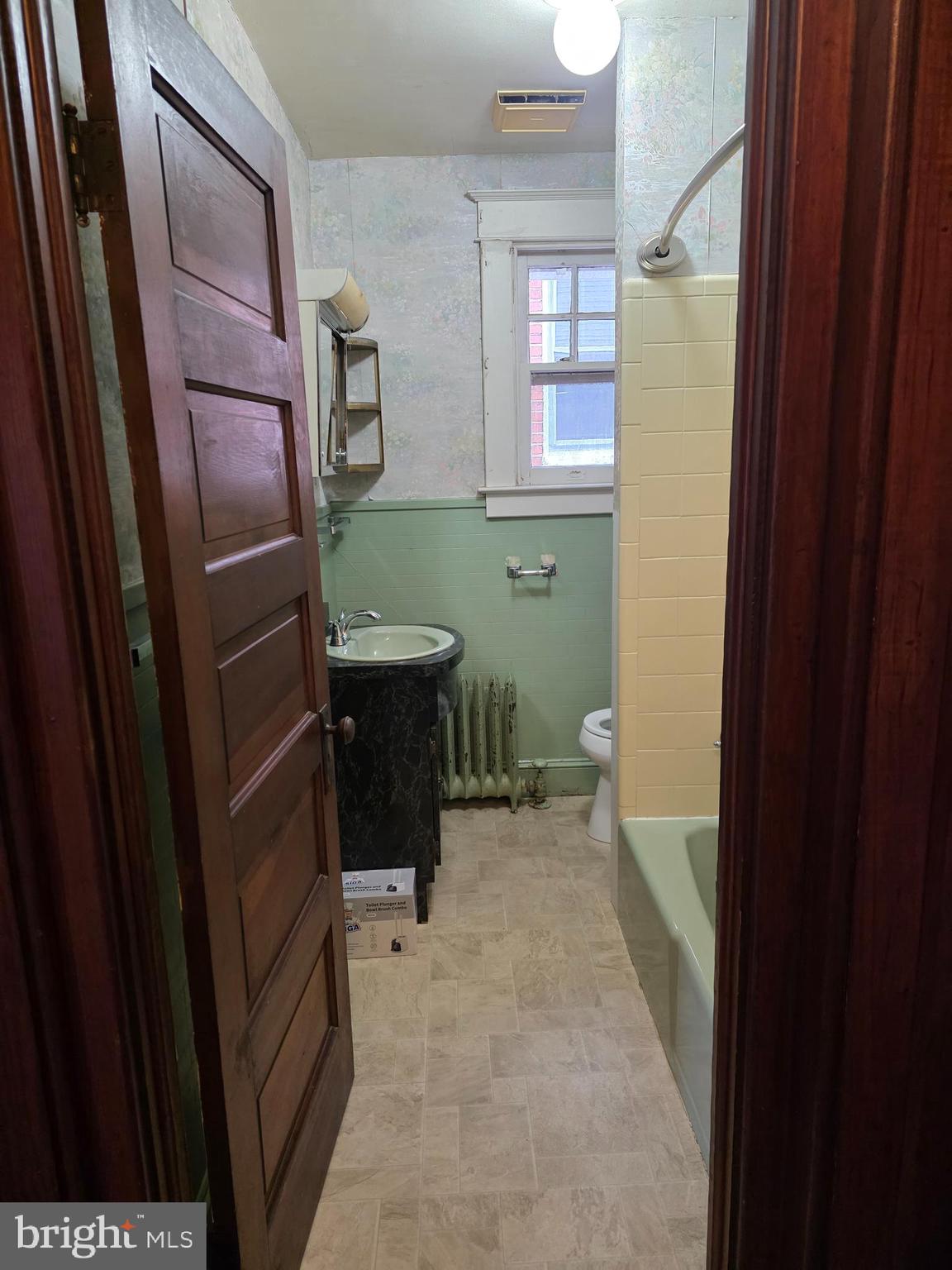 104 East 7th Street Frederick, MD 21701 - Photo 16 of 28 a bathroom with a sink a toilet and tub