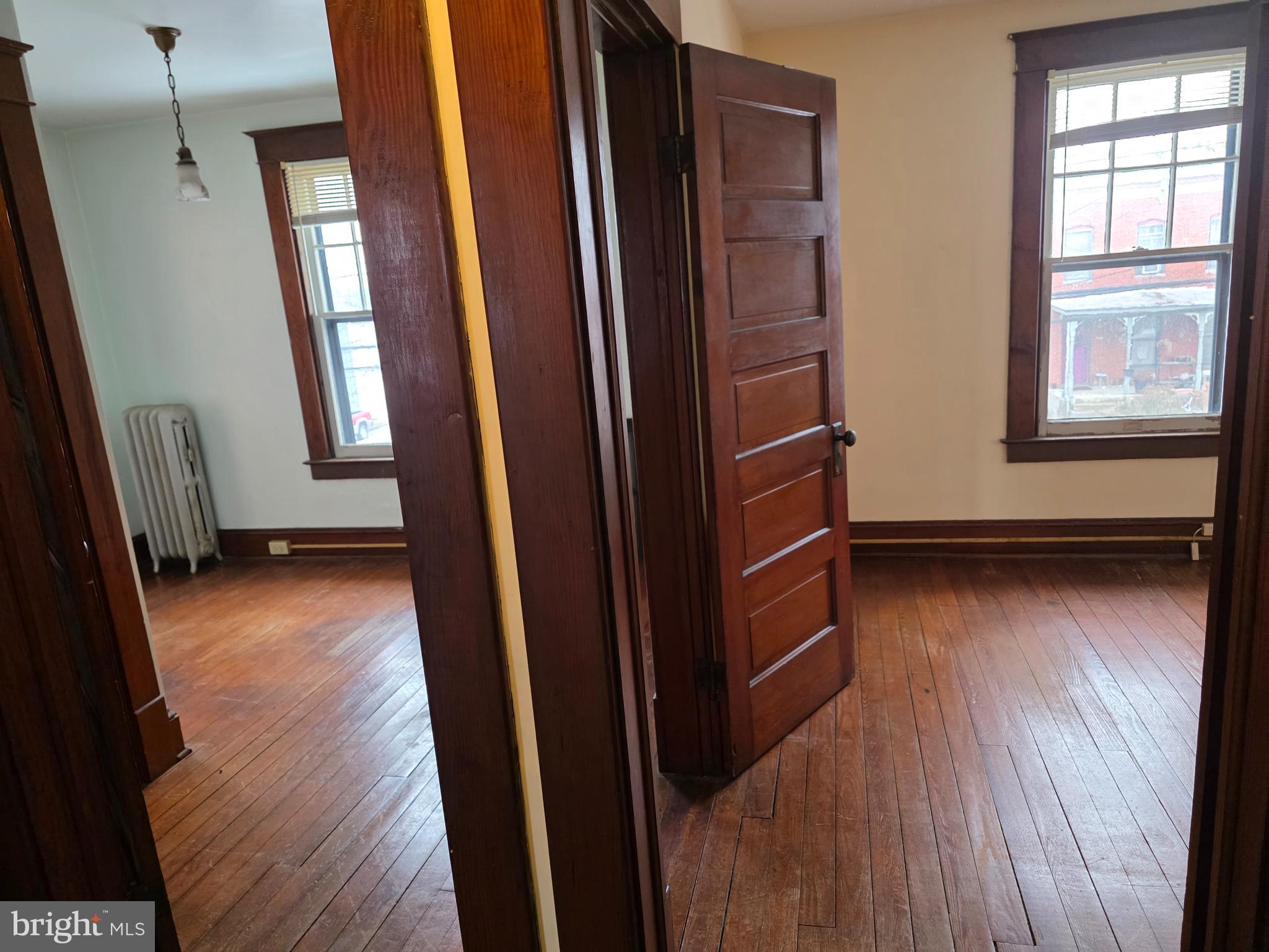 104 East 7th Street Frederick, MD 21701 - Photo 20 of 28 a view of walk in closet with window and wooden floor