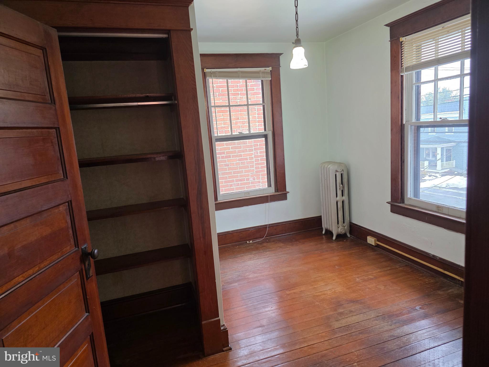 104 East 7th Street Frederick, MD 21701 - Photo 22 of 28 a view of an empty room with a window and wooden floor