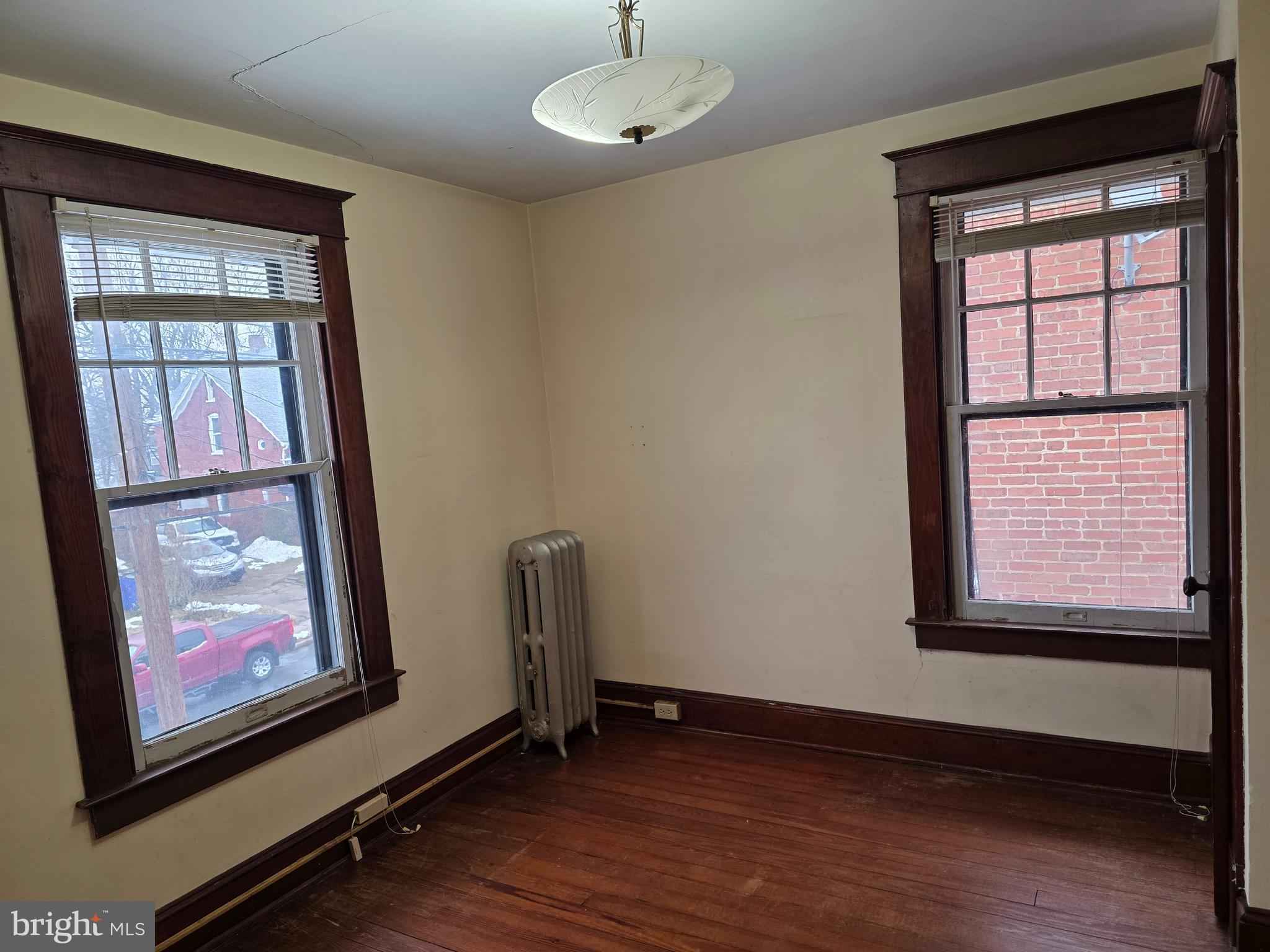 104 East 7th Street Frederick, MD 21701 - Photo 23 of 28 a view of an empty room with wooden floor and a window