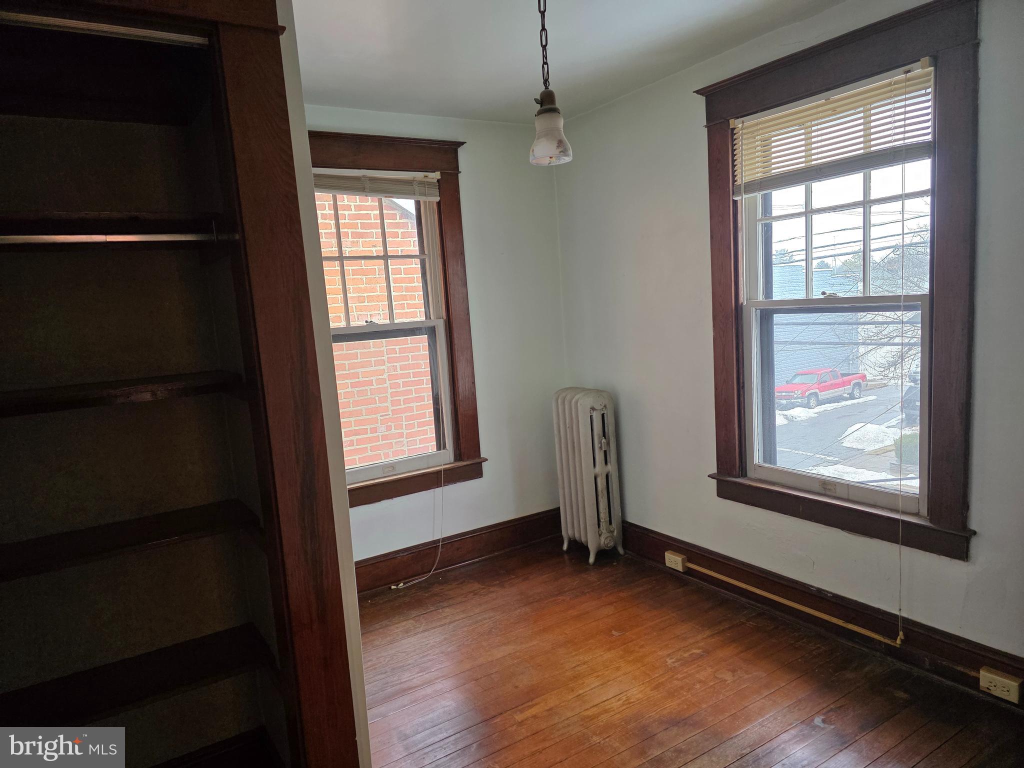 104 East 7th Street Frederick, MD 21701 - Photo 24 of 28 a view of an empty room with wooden floor and a window