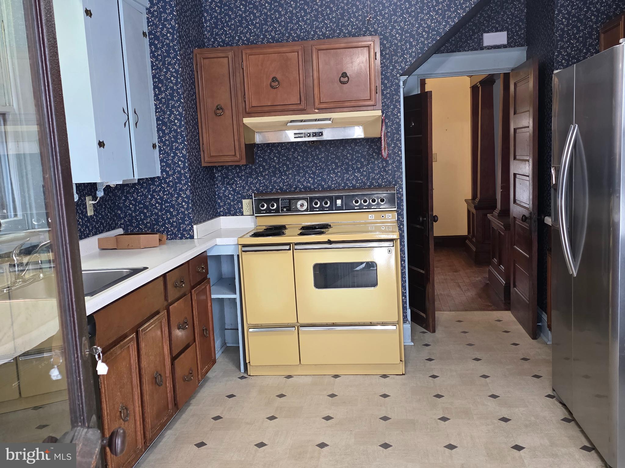 104 East 7th Street Frederick, MD 21701 - Photo 6 of 28 a kitchen with a stove and a refrigerator