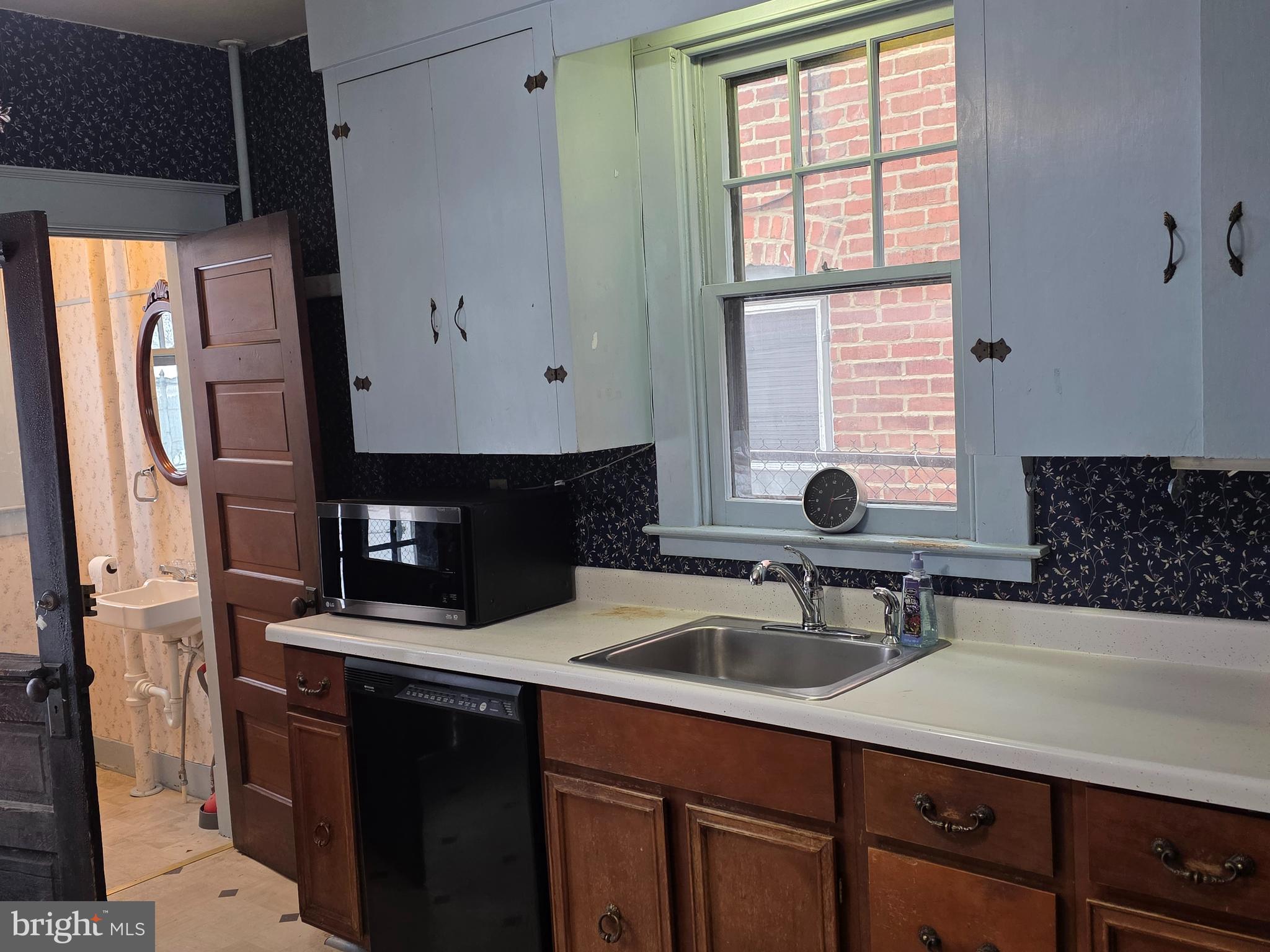104 East 7th Street Frederick, MD 21701 - Photo 7 of 28 a kitchen with stainless steel appliances a sink dishwasher a refrigerator and cabinets